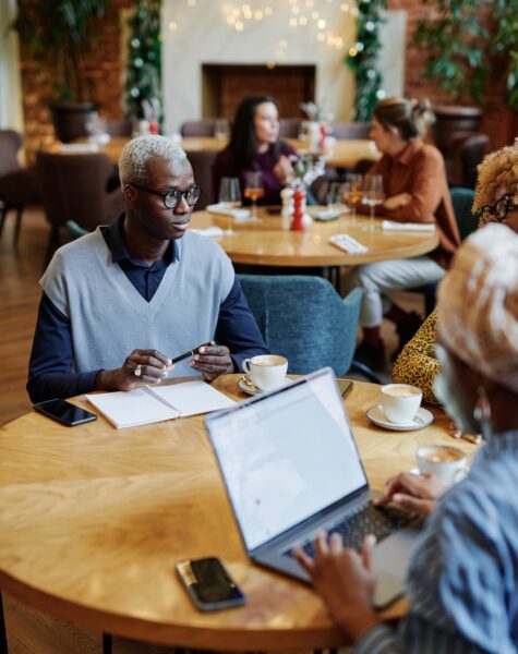 Business people working in cafe Young businessman discussing working moments together with his colleagues during business meeting in cafe
