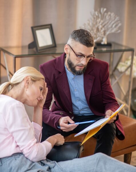 Psychoanalyst holding folder and speaking to client Psychoanalyst holding folder. Bearded psychoanalyst holding folder and speaking to client
