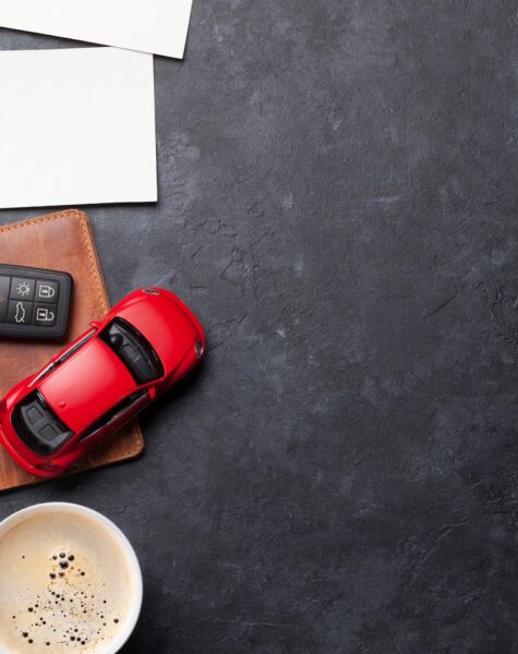 Travel vacation background concept Travel vacation concept with passport, car toy and photo frames on stone backdrop. Top view with copy space. Flat lay