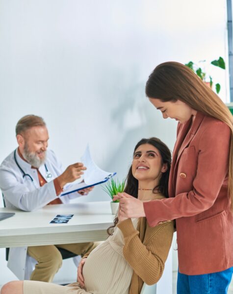 young expectant lesbian couple having doctor appointment looking lovingly at each other, ivf concept young expectant lesbian couple having doctor appointment looking lovingly at each other, ivf concept